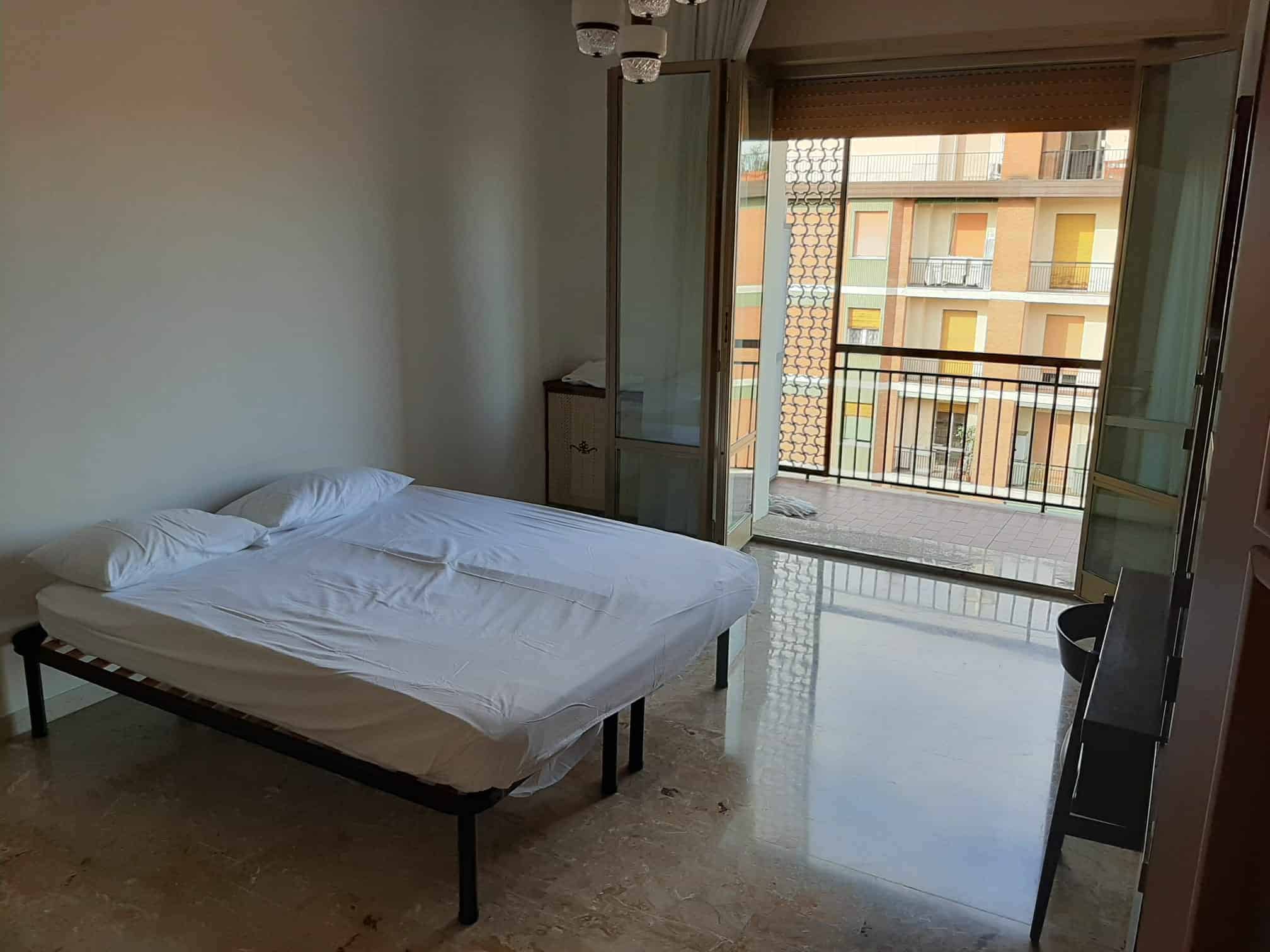 camera con letto e balcone aperto